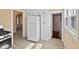 Open kitchen space featuring built-in cabinets, a white refrigerator, and hardwood style laminate floors at 1023 W 7Th St, Anderson, IN 46016