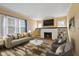 Staged living room features a decorative fireplace, built-in shelving and comfortable seating arrangement at 1023 W 7Th St, Anderson, IN 46016