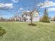 A large backyard with healthy green grass, surrounded by a privacy fence at 10827 Putnam Pl, Carmel, IN 46032