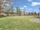 Well-maintained backyard with lush green grass, mature trees, and a wooden fence line at 10827 Putnam Pl, Carmel, IN 46032