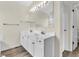 Bright bathroom featuring a dual sink vanity and a large mirror at 10827 Putnam Pl, Carmel, IN 46032
