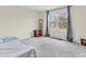 Bedroom featuring a large window with ample natural light and modern gray carpet at 10827 Putnam Pl, Carmel, IN 46032