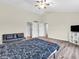 Bright bedroom features vaulted ceiling, wood floors, and ensuite bathroom at 10827 Putnam Pl, Carmel, IN 46032