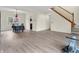 Dining room with wood-look floors, chandelier, staircase, and a doorway to the kitchen at 10827 Putnam Pl, Carmel, IN 46032