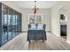 Formal dining area with wood-look floors, chandelier, and cabinet at 10827 Putnam Pl, Carmel, IN 46032