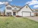 Traditional-style home featuring a three-car garage, lawn, and driveway at 10827 Putnam Pl, Carmel, IN 46032