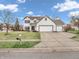 Traditional-style home featuring a three-car garage, lawn, and driveway at 10827 Putnam Pl, Carmel, IN 46032