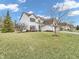 Traditional-style home featuring a three-car garage, lawn, and driveway at 10827 Putnam Pl, Carmel, IN 46032