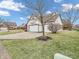 Traditional-style home featuring a three-car garage, lawn, and driveway at 10827 Putnam Pl, Carmel, IN 46032