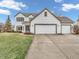 Traditional-style home featuring a three-car garage, lawn, and driveway at 10827 Putnam Pl, Carmel, IN 46032