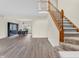 Entryway features hardwood floors, staircase, and view into dining room at 10827 Putnam Pl, Carmel, IN 46032
