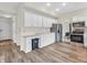 Bright kitchen features white cabinets, stainless steel appliances, and wood-look flooring at 10827 Putnam Pl, Carmel, IN 46032
