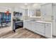 Eat-in kitchen features white cabinets, stainless steel appliances, and wood-look flooring at 10827 Putnam Pl, Carmel, IN 46032