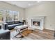 Inviting living room with a fireplace, sleek sofas, and natural light at 10827 Putnam Pl, Carmel, IN 46032