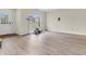Bright living room with wood-look floors, a large window, and a door to the outside at 10827 Putnam Pl, Carmel, IN 46032