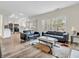Bright living room features hardwood floors, comfortable sofas, and natural light from windows at 10827 Putnam Pl, Carmel, IN 46032