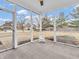 Inviting screened porch with concrete flooring and views of the backyard and surrounding neighborhood homes at 10827 Putnam Pl, Carmel, IN 46032