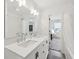 Bathroom with double sink vanity, quartz countertop, modern fixtures, and access to the bedroom at 139 Mckim Ave, Indianapolis, IN 46201