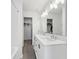 Modern bathroom featuring a double sink vanity, quartz countertop, and a separate walk-in closet at 139 Mckim Ave, Indianapolis, IN 46201