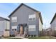 Charming two-story duplex with gray siding, a walkway, and well-manicured lawns at 139 Mckim Ave, Indianapolis, IN 46201
