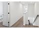Hallway with wooden floors leading to a staircase and a view into the living room at 139 Mckim Ave, Indianapolis, IN 46201