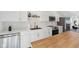 Updated kitchen boasts white cabinetry, stainless steel appliances, and a butcher block island at 139 Mckim Ave, Indianapolis, IN 46201