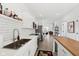 Open-concept kitchen with white cabinets, stainless steel appliances, an island and view into the dining and living areas at 139 Mckim Ave, Indianapolis, IN 46201