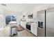 Well-lit kitchen with white cabinets, stainless steel appliances, island, and sliding glass door to backyard at 139 Mckim Ave, Indianapolis, IN 46201