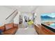 Bright open-plan living area with wood floors, modern decor, a dining area, and stairs to the upper level at 139 Mckim Ave, Indianapolis, IN 46201