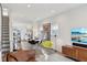 Bright open-plan living area with wood floors, modern decor, a dining area, and stairs to the upper level at 139 Mckim Ave, Indianapolis, IN 46201