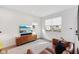 Modern living room with a media console, comfy sofa, bright window, and plush rug at 139 Mckim Ave, Indianapolis, IN 46201