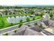 Serene community aerial with a pond, fountain, lush greenery, and well-maintained landscaping at 13902 Rue Royale Ln # 62, McCordsville, IN 46055