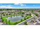 Beautiful aerial showcasing a community with a pond, fountain, and lush green landscaping at 13902 Rue Royale Ln # 62, McCordsville, IN 46055