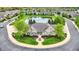 Striking aerial view of a brick home, manicured lawn, landscaping, and circular driveway at 13902 Rue Royale Ln # 62, McCordsville, IN 46055