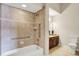 Bathroom with a bathtub, decorative tiled walls, safety handles, and a vanity with cabinets at 13902 Rue Royale Ln # 62, McCordsville, IN 46055