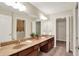 Bathroom features a double vanity with neutral countertop, dark cabinets, and two decorative plants at 13902 Rue Royale Ln # 62, McCordsville, IN 46055