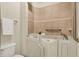 A bathroom with a walk-in tub featuring safety grab bars and a decorative tiled wall at 13902 Rue Royale Ln # 62, McCordsville, IN 46055