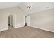 Spacious bedroom with neutral carpet, paint, and vaulted ceiling with chandelier at 13902 Rue Royale Ln # 62, McCordsville, IN 46055