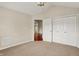 Bedroom with carpet, closet, overhead lighting, and access to other rooms with hardwood flooring at 13902 Rue Royale Ln # 62, McCordsville, IN 46055