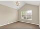 Carpeted room with white walls, a large window with blinds, and a modern ceiling light fixture at 13902 Rue Royale Ln # 62, McCordsville, IN 46055