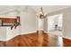 Open-concept dining area with hardwood floors and kitchen bar at 13902 Rue Royale Ln # 62, McCordsville, IN 46055