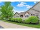 A charming home with a manicured lawn, lush hedges, brick accents and stone facade at 13902 Rue Royale Ln # 62, McCordsville, IN 46055