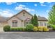 Charming stone home featuring a beautiful brick arch above the large window and manicured landscaping at 13902 Rue Royale Ln # 62, McCordsville, IN 46055