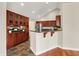 Well-equipped kitchen featuring tile floors, wooden cabinets, and granite countertops at 13902 Rue Royale Ln # 62, McCordsville, IN 46055