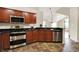 Well-lit kitchen features stainless steel appliances, wood cabinets, and a decorative backsplash at 13902 Rue Royale Ln # 62, McCordsville, IN 46055