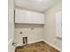 A laundry room with tile floors, white cabinets, and visible hookups for appliances at 13902 Rue Royale Ln # 62, McCordsville, IN 46055
