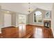 Bright and airy living room with hardwood floors, fireplace, and a large window at 13902 Rue Royale Ln # 62, McCordsville, IN 46055
