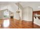 Spacious living room featuring hardwood floors, a fireplace, and plenty of natural light at 13902 Rue Royale Ln # 62, McCordsville, IN 46055
