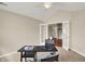 Office space features neutral walls, a ceiling fan, and connects to a bright adjacent room at 13902 Rue Royale Ln # 62, McCordsville, IN 46055