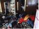 This bedroom needs extensive cleaning. Items are strewn throughout the room at 1516 Sycamore St, Columbus, IN 47201